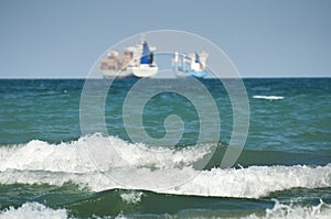 Commercial container ship on blue sky