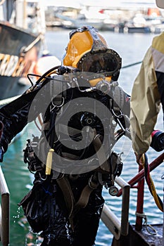 Commercial diver exiting water at harbor photo