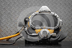Commercial diving helmet closeup photo with steel background