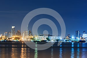 Commercial docks with light at night with a ship