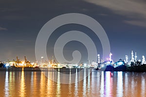 Commercial docks with light at night with a ship and crane