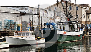 Commercial fishing boats docked in a working canal in Portland Maine USA