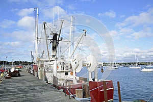 Commercial fishing boats by a wood dock