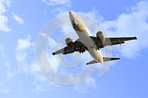 Commercial flight airplane flying on blue sky in travel tourism concept