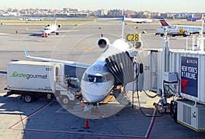 Commercial jet aircraft on tarmac loading its cargo at airport before flight