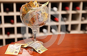 Commercial license You`re A wine glass filled with money in front