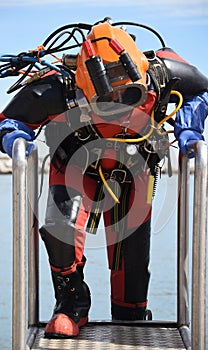 Commercial offshore diver with anti contamination suit and helmet