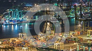 Commercial port of Singapore night timelapse. Bird eye panoramic view of busiest Asian cargo port