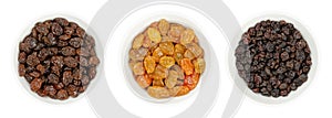 Commercial raisins, golden raisins and small Zante currants in white bowls
