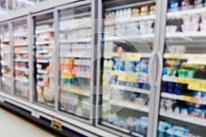 Commercial refrigerators in a large supermarket blurred background