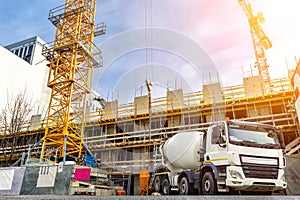 Commercial or residential corporate hightower building construction site with different heavy machinery. Concrete cement mixer