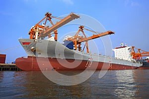 Commercial ship floating in ship yard loading container use for