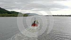 Commercial Ship Traversing a Lake on an Overcast Day