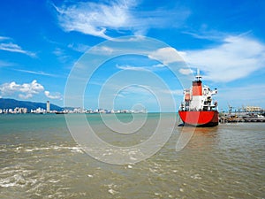 Commercial ships in port with sea and blue sky in Penang, Malaysia.