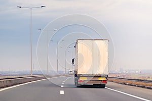 Commercial trailer truck in motion on freeway