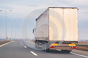 Commercial trailer truck in motion on freeway