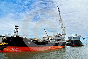 Commercial vessel and RO-RO ship berth to quay area of dock fo