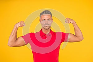 Commit to be fit. Strong man flex arms yellow background. Physical strength. Building strong biceps and triceps. Muscle photo