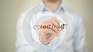 Commitment, Man writing on transparent screen photo
