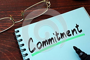 Commitment written on a notepad.