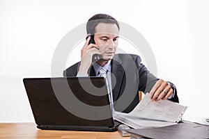 Committed employee checking files at phone
