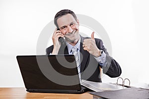 Committed employee smiling at phone thumbs up