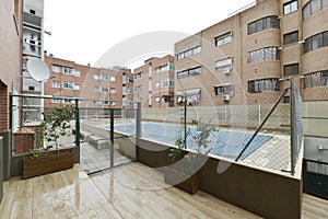 Common areas with a pool covered with a canvas for winter protection in a residential housing development photo