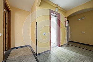 Common areas of a residential building with a red elevator