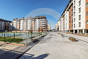 Common areas of an urbanization with swimming pools, benches and planters