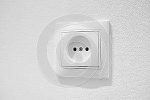 Common cheap plastic AC power wall outlet. German circular recess socket with two round holes for 2 pins europlugs types