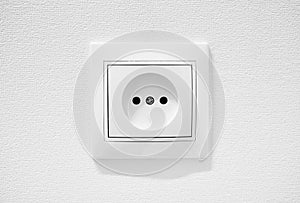 Common cheap plastic AC power wall socket. German circular recess socket with two round holes for 2 pins europlugs types