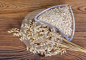 Common oat ears and rolled oats pile. Avena sativa
