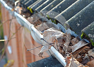 Common problem caused by Clogged Gutters with autumn leaves.  Unclog Gutters and Clean Downspouts