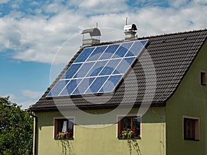 Common solar panels on modern roof with dark  blue photocell