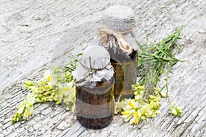 Common toadflax (Linaria vulgaris) and pharmaceutical bottles photo