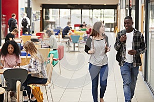 Communal Area Of Busy College Campus With Students