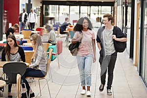 Communal Area Of Busy College Campus With Students