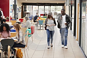 Communal Area Of Busy College Campus With Students