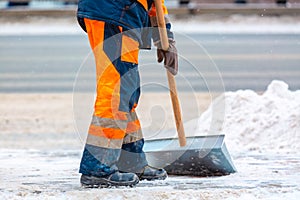 Communal services worker sweeps snow from road in winter, Cleaning city streets and roads after snow storm. Moscow, Russia