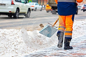 Communal services worker sweeps snow from road in winter, Cleaning city streets and roads during snowstorm. Moscow, Russia