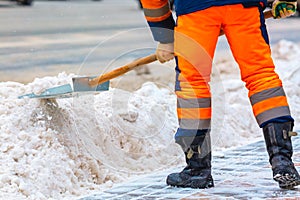 Communal services worker sweeps snow from road in winter, Cleaning city streets and roads during snowstorm. Moscow, Russia