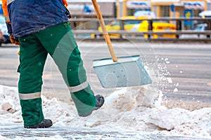 Communal services worker sweeps snow from road in winter, Cleaning city streets and roads during snowstorm. Moscow, Russia