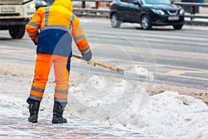 Communal services worker sweeps snow from road in winter, Cleaning city streets and roads during snowstorm. Moscow, Russia