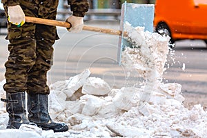 Communal services worker sweeps snow from road in winter, Cleaning city streets and roads during snowstorm. Moscow, Russia