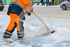 Communal services worker sweeps snow from road in winter, Cleaning city streets and roads after snow storm. Moscow, Russia