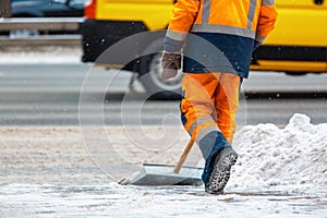 Communal services worker sweeps snow from road in winter, Cleaning city streets and roads after snow storm. Moscow, Russia