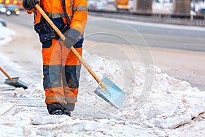 Communal services worker sweeps snow from road in winter, Cleaning city streets and roads after snow storm. Moscow, Russia