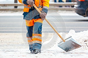 Communal services worker sweeps snow from road in winter, Cleaning city streets and roads after snow storm. Moscow, Russia