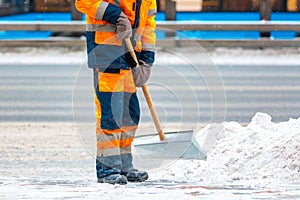 Communal services worker sweeps snow from road in winter, Cleaning city streets and roads after snow storm. Moscow, Russia