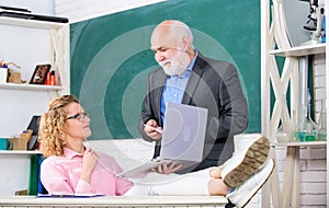 Communicate clearly and effectively. Man mature school teacher and carefree girl student with laptop. High school